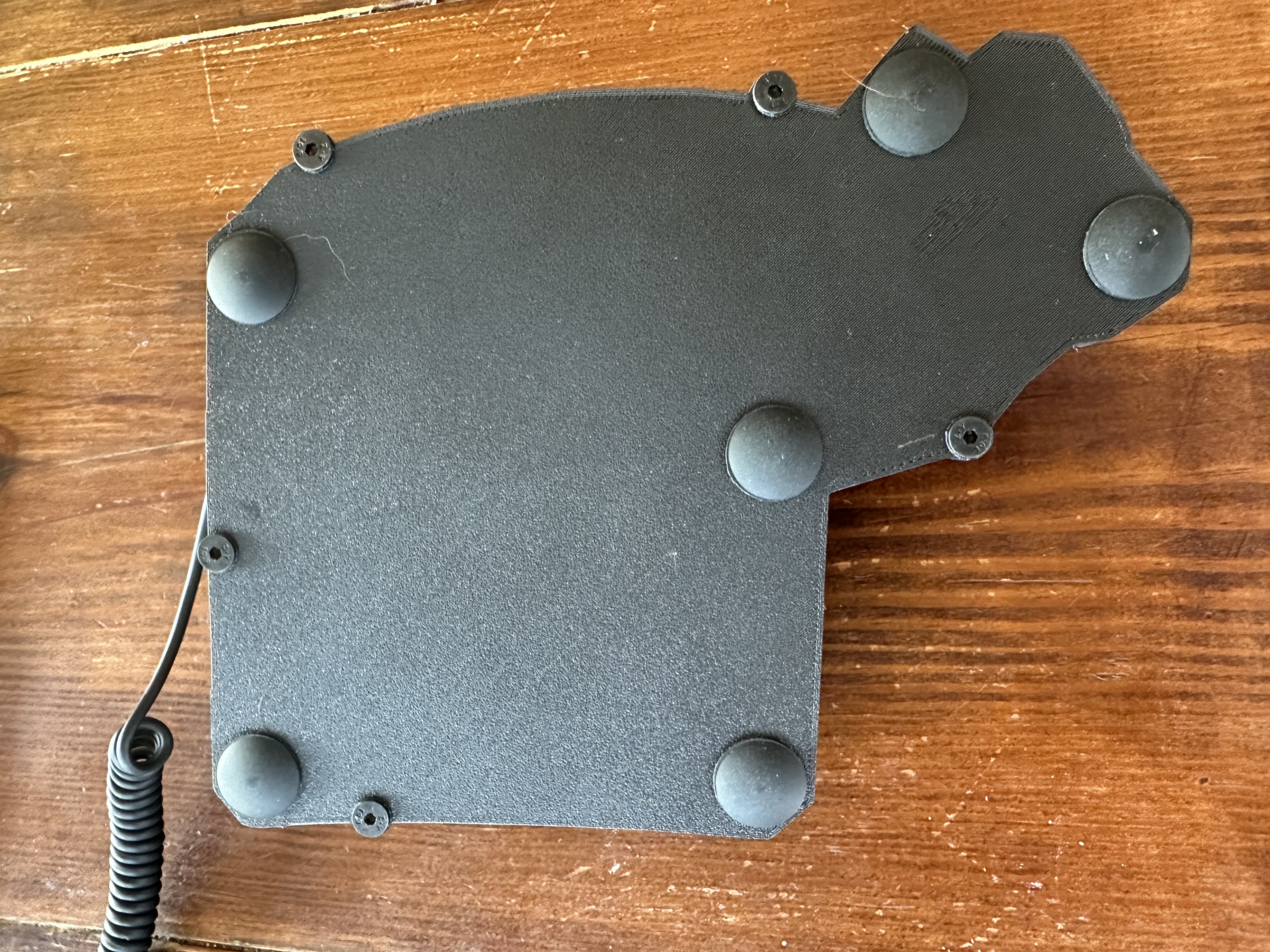 The bottom of one half of the keyboard showing the rubber feet